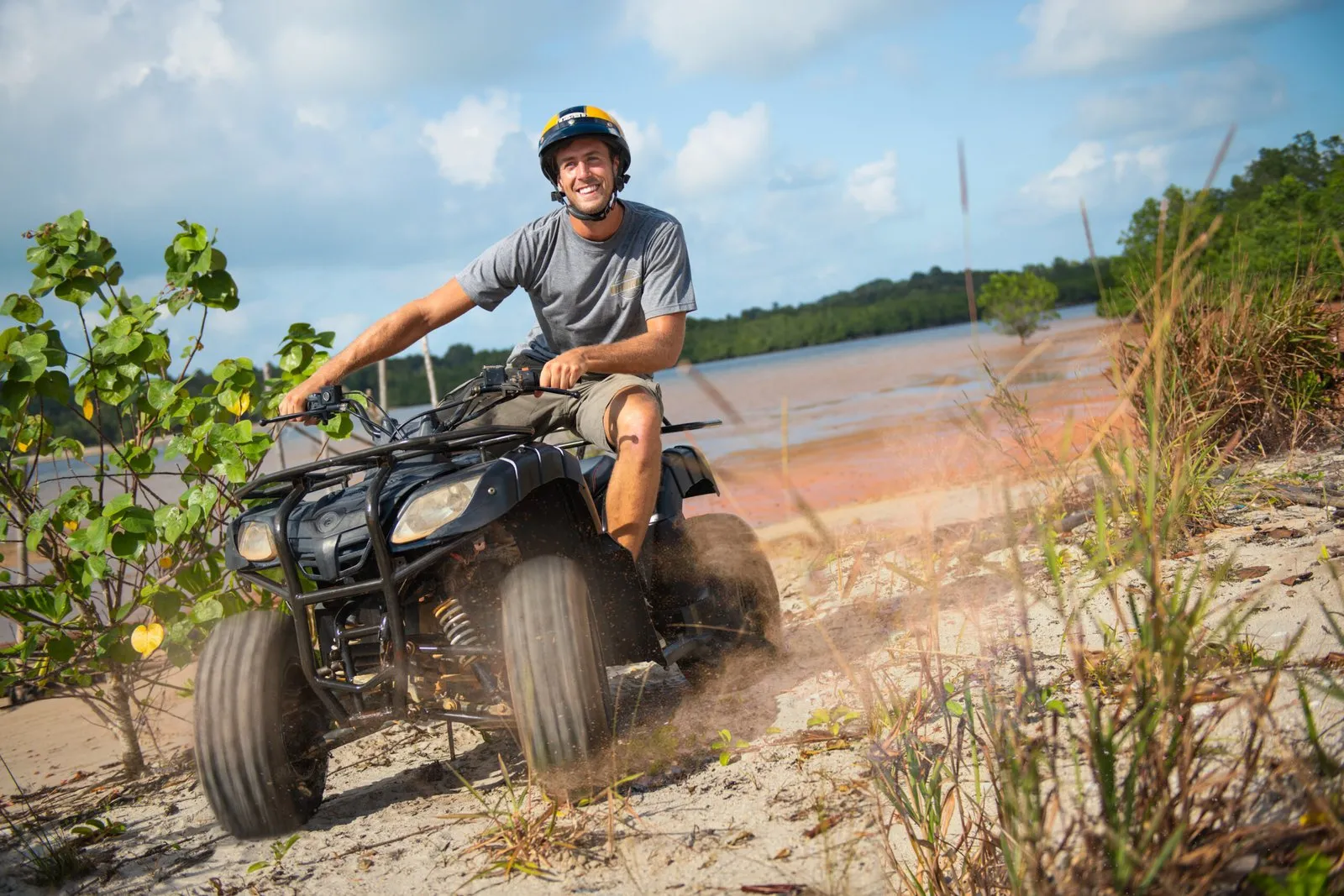 Guests riding ATVs through tropical terrain at Natra Bintan