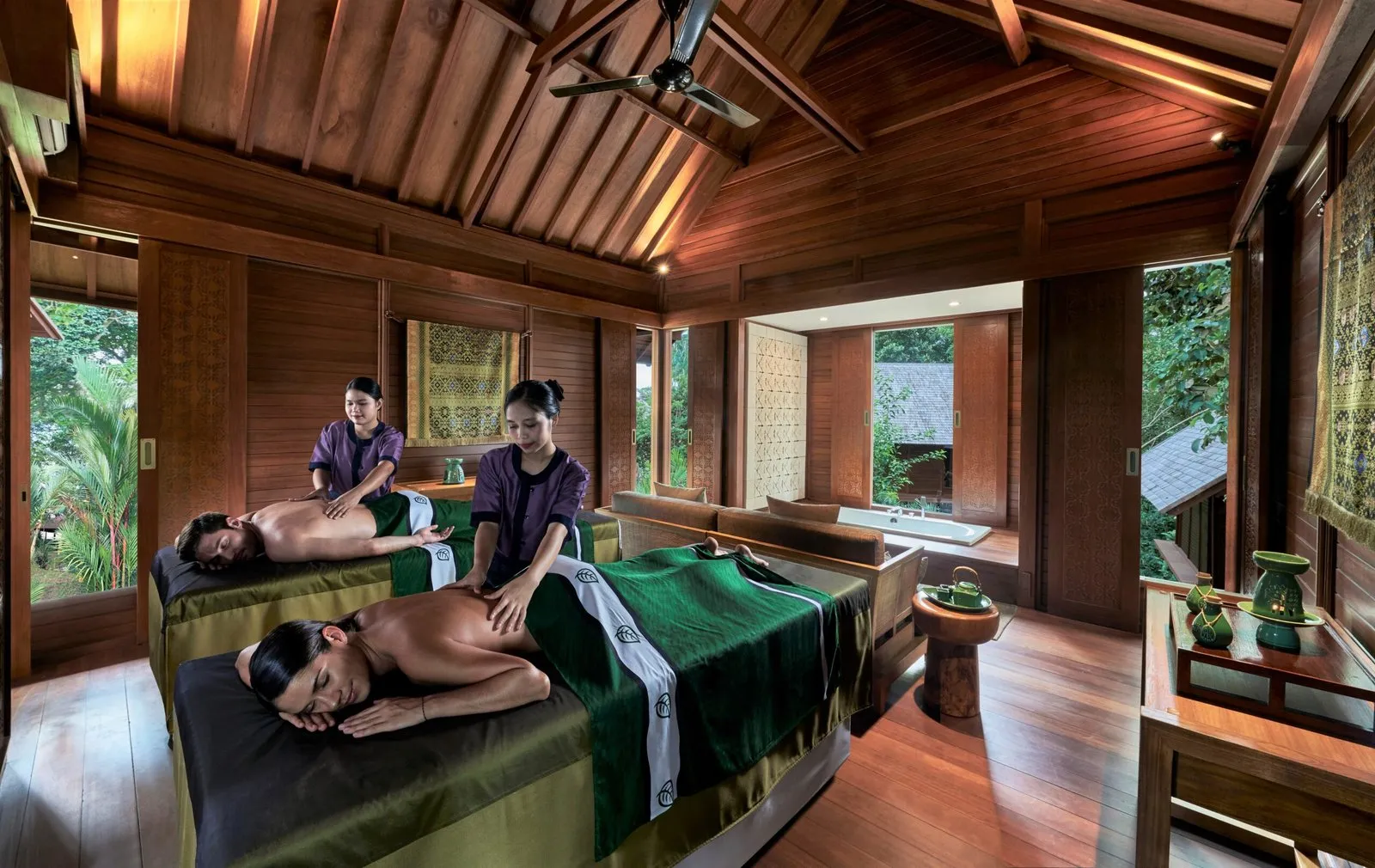 A couple receiving a spa treatment at a Bintan Resorts hilltop spa
